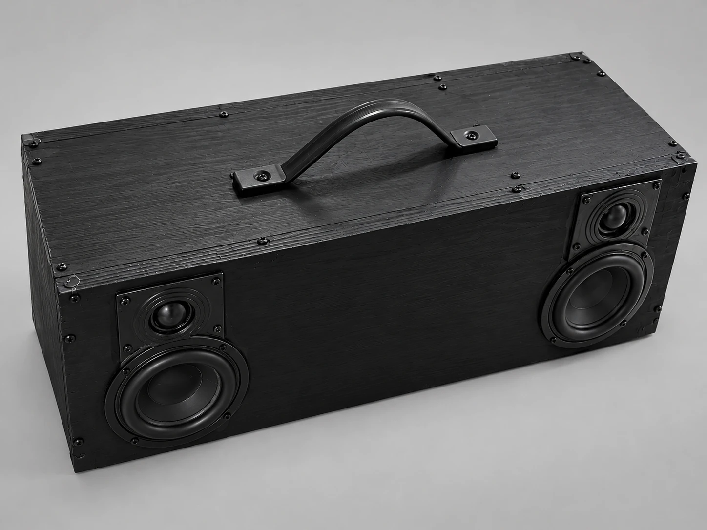 Homemade Bluetooth speaker in a black wooden box with two woofers, two tweeters and a carry handle